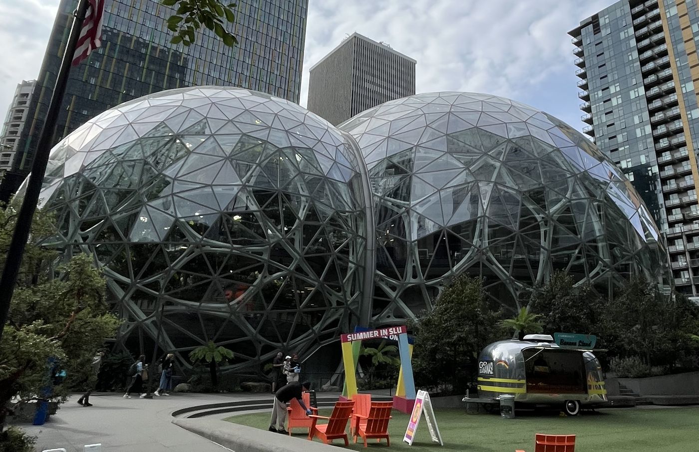 The Amazon Spheres in Seattle on a cloudy day, with the Banana Stand trailer parked on the lawn out front
